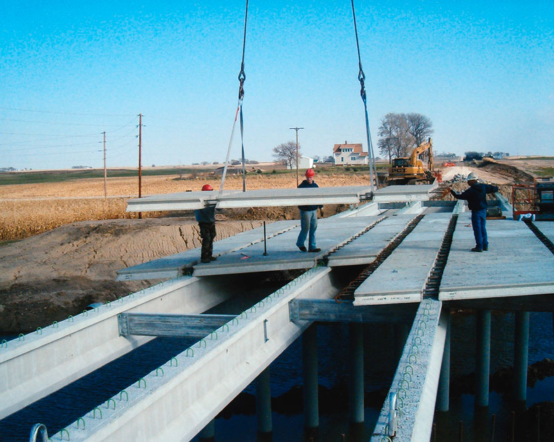 Installing prestressed concrete bridge slabs